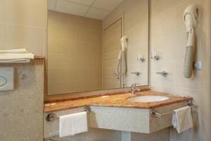 a bathroom with a sink and a phone at Residence Villa Lo Scoglietto in San Vincenzo