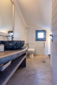 a bathroom with a sink and a toilet at Milian Suite in Adamantas +40 photos