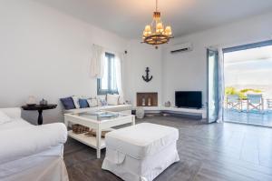 a white living room with a couch and a table at Milian Suite in Adamantas