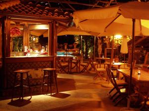 a restaurant with tables and chairs and umbrellas at Residence Villaggio Verde in Sorrento