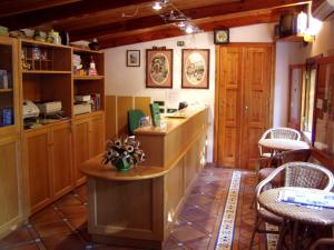 a kitchen with a counter and some tables and chairs at Residence Villaggio Verde in Sorrento