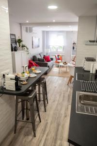 a kitchen and living room with a table and a couch at Apartamento Valtour Valladolid in Valladolid