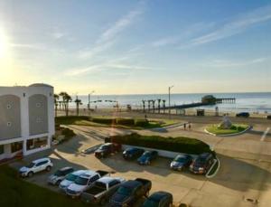 a parking lot with cars parked next to the beach at Casa Del Mar Beach View in Galveston