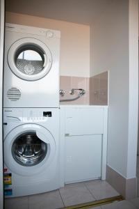 a white washer and dryer in a kitchen at The Palms Apartments in Merimbula