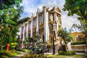a building with a statue in front of it at Pingdoi Hualin Boutique Hotel in Chiang Mai