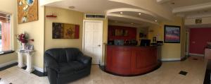 a living room filled with furniture and a large window at Gateway Inn and Suites San Francisco SFO Airport in San Bruno