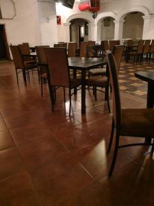 a dining room with tables and chairs in a building at Hotel del Conde in Guanajuato