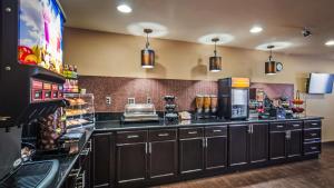 a large kitchen with black cabinets and a counter at Best Western Parker Inn in Parker
