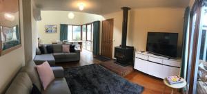 a living room with a couch and a fireplace at Beach Life in Torquay