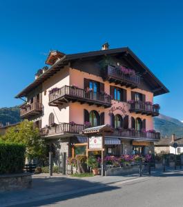 a large pink building with balconies on a street at Hotel Residence Chateau in Saint-Pierre