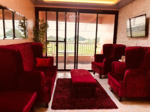 a waiting room with red couches and a red rug at Luzville Residences C10 in Naic