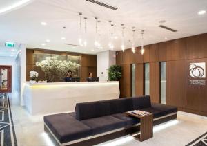 a lobby with a couch and a reception desk at The Envoy Hotel Abuja in Abuja