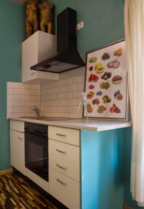 a kitchen with a counter with a painting of food at Art Apartments in Dresden
