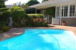 a swimming pool in front of a house at Bicycle Lodge Apartment in Tokai