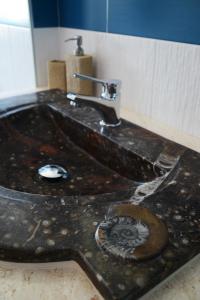 a bathroom sink with a marble counter top at Hotel La Favorita in Cala Gonone