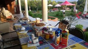 a table with food on it on a patio at Orange Ville in Villamassargia