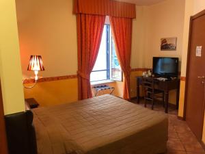 En eller flere senger på et rom på Locanda San Cosimato