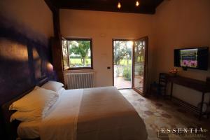 a bedroom with a bed and a sliding glass door at Agriturismo Essentia dimora rurale in Larino