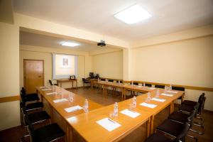 a large room with long tables and chairs at Kolping in Shkodër