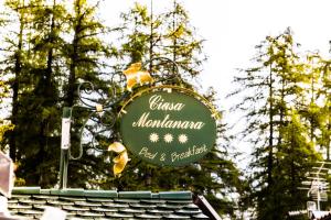 ein Schild für ein Restaurant auf dem Dach in der Unterkunft Ciasa Montanara in Stern