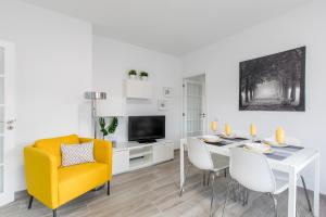 ein Wohnzimmer mit einem Esstisch und einem gelben Stuhl in der Unterkunft Santa Cruz Downtown in Santa Cruz de Tenerife