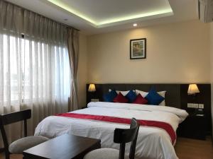 a hotel room with a bed and a window at Kaveri Inn in Kathmandu