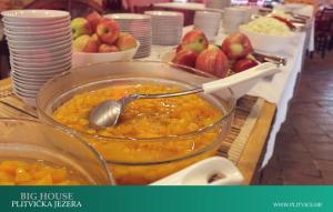 a table topped with a bowl of food with apples at House Korina B&B in Ličko Petrovo Selo +3 photos