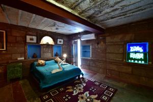 a bedroom with a bed and a tv in it at The Arch Boutique Home stay in Jodhpur