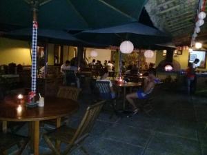 a group of people sitting at tables in a restaurant at Cimajasquare Hotel & Restaurant in Palabuhanratu