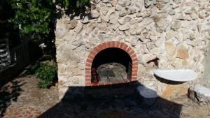 a stone wall with a fireplace with a sink at ApartMarin in Trogir