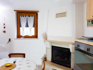 a dining room with a table and a fireplace at Rental House in Cisternino in Cisternino