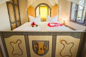 a bedroom with a large bed with white sheets at Prinzessinnenturm in Blankenburg