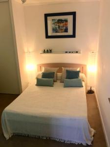 a bedroom with a large white bed with two pillows at L'Alivu in Nice