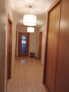an empty hallway in a building with a door and a room at Pedrouzo Suites in O Pedrouzo