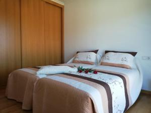 a bedroom with a large bed with flowers on it at Pedrouzo Suites in O Pedrouzo