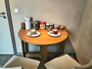 a small table with cups and plates of food on it at l'Ardenne buissonière in Bastogne