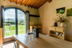 a kitchen with a table with two glasses of wine at Tenuta San Jacopo - Agriturismo in Cavriglia