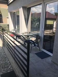 a patio with a table and chairs on a balcony at Casa Mario in Baile Felix +24 photos