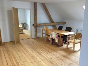 a dining room with a wooden table and chairs at Nocleg na Mazurach in Stacze