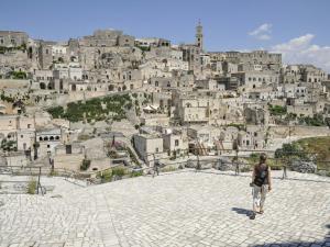 a woman walking in front of a city at Masseria La Meridiana in Altamura