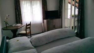 a bedroom with two pillows on a bed with a table at Gasthaus Post in Muotathal