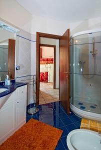 a bathroom with a shower and a sink and a tub at Casa Turchese con fantastica vista in Vercana
