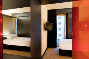a hotel room with two beds and a tv at Axel Hotel Berlin-Adults Only in Berlin