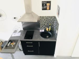 a small kitchen with a sink and a stove at CosyStudio2 Site du Futuroscope in Jaunay-Marigny
