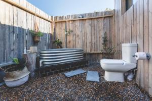a toilet sitting in a yard next to a fence at The Farmstead in Franschhoek +43 photos