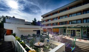 a building with a patio with tables and chairs at Hotel Fontana in Bad Kissingen