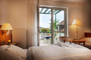 a hotel room with a bed and a large window at Hotel Fontana in Bad Kissingen +33 photos