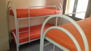 two bunk beds in a room with a window at Villa Cloe in San Vito lo Capo