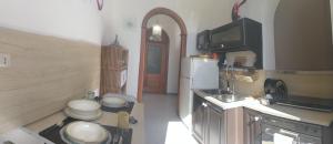 a small kitchen with a sink and a refrigerator at ReggiaHome Apartment in Caserta