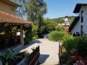 a driveway leading to a house with a car parked at Apartment Holiday in Vrnjačka Banja